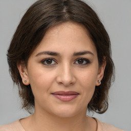 a portrait of a woman with brown hair.